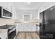 Bright kitchen with white cabinets and modern appliances at 13715 Mayes Rd, Huntersville, NC 28078