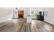View of the living room with a brick fireplace and an open-concept kitchen at 13715 Mayes Rd, Huntersville, NC 28078