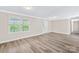 Bright living room with large window offering outdoor views, featuring wood flooring at 13715 Mayes Rd, Huntersville, NC 28078
