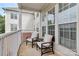 Relaxing balcony featuring two cushioned chairs, a small table, and neutral exterior paint at 14451 San Paolo Ln, Charlotte, NC 28277
