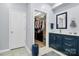 Bathroom featuring a vanity with cabinets and a view into the walk-in closet at 14451 San Paolo Ln, Charlotte, NC 28277