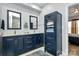 Stylish bathroom featuring a double vanity, linen cabinet, and elegant mirrors at 14451 San Paolo Ln, Charlotte, NC 28277