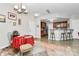 A dining area with a chandelier, wooden chairs, and a small kitchen island with bar stools at 14451 San Paolo Ln, Charlotte, NC 28277