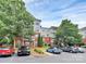 Brick apartment building with balconies and mature trees in a well-maintained community at 14451 San Paolo Ln, Charlotte, NC 28277