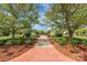 Nicely landscaped community grounds with brick walkway and shade trees at 14451 San Paolo Ln, Charlotte, NC 28277