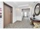 Bright condo hallway with elevator access and decorative table with mirror at 14451 San Paolo Ln, Charlotte, NC 28277