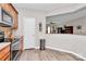 Bright kitchen featuring modern appliances, wooden cabinets and access to the open-concept living area at 14451 San Paolo Ln, Charlotte, NC 28277