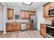 Well-equipped kitchen featuring stainless steel appliances and warm wood cabinetry at 14451 San Paolo Ln, Charlotte, NC 28277