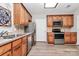 Modern kitchen with stainless steel appliances, wood cabinets, and recessed lighting at 14451 San Paolo Ln, Charlotte, NC 28277
