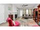 Cozy living area with a fireplace, a plush sofa, decorative curtains and a ceiling fan at 14451 San Paolo Ln, Charlotte, NC 28277
