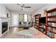 Cozy living room with modern decor, a fireplace, neutral walls, and a ceiling fan at 14451 San Paolo Ln, Charlotte, NC 28277