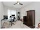 Bright home office space with large windows, modern desk, and dark wood cabinet at 14451 San Paolo Ln, Charlotte, NC 28277
