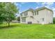 Expansive green backyard featuring well-maintained lawn and a two-story home with a light-colored exterior at 14911 Taggert Trail Dr, Charlotte, NC 28273