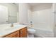 Bathroom featuring a vanity with sink, toilet, and a combined shower and bathtub with white tile surround at 14911 Taggert Trail Dr, Charlotte, NC 28273
