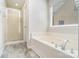 Bathroom with a shower and separate tub with jets, plus one large window for natural light at 14911 Taggert Trail Dr, Charlotte, NC 28273