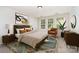 Bright bedroom featuring neutral walls, a modern bed, accent chair, and decor providing a cozy space at 14911 Taggert Trail Dr, Charlotte, NC 28273