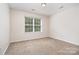 Cozy bedroom with neutral walls and carpet, featuring a window for natural light and a simple, inviting space at 14911 Taggert Trail Dr, Charlotte, NC 28273