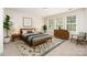 Spacious bedroom with neutral colored furniture, carpet, and walls, plus sun-filled windows at 14911 Taggert Trail Dr, Charlotte, NC 28273