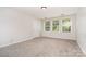 This bedroom has neutral walls and carpeting with three sun-filled windows at 14911 Taggert Trail Dr, Charlotte, NC 28273