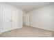 Large bedroom with double door closet, and an entry to the stairs, offering a canvas ready for customization at 14911 Taggert Trail Dr, Charlotte, NC 28273