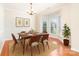 Elegant dining room featuring a bay window, modern lighting, and stylish decor at 14911 Taggert Trail Dr, Charlotte, NC 28273