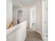 Hallway with neutral carpeting and paint, leading to a bathroom and bedroom at 14911 Taggert Trail Dr, Charlotte, NC 28273