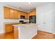 Well-lit kitchen featuring granite countertops, stainless steel appliances, and wood cabinets and flooring at 14911 Taggert Trail Dr, Charlotte, NC 28273