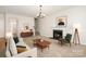 Bright living room features a fireplace, modern chandelier, and neutral decor at 14911 Taggert Trail Dr, Charlotte, NC 28273