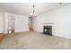 Open-concept living room featuring a fireplace and staircase with hardwood floors at 14911 Taggert Trail Dr, Charlotte, NC 28273