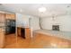 Bright open concept living space with hardwood floors, fireplace, and kitchen island at 14911 Taggert Trail Dr, Charlotte, NC 28273