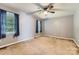 Cozy bedroom with neutral carpeting, a ceiling fan, and two windows with natural light at 1506 Union New Hope Rd, Gastonia, NC 28056