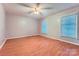 Bright bedroom with wood floors, a ceiling fan, and two windows for ample natural light at 1506 Union New Hope Rd, Gastonia, NC 28056