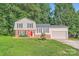 Charming two-story home with a bright red front door, well-maintained lawn, and a one-car garage at 1506 Union New Hope Rd, Gastonia, NC 28056