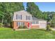 Charming two-story home with well-maintained landscaping and a welcoming red door at 1506 Union New Hope Rd, Gastonia, NC 28056
