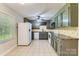 Well-lit kitchen with tiled flooring, updated appliances, and ample cabinet space at 1506 Union New Hope Rd, Gastonia, NC 28056