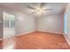 Spacious living room featuring wood floors, a ceiling fan, and natural light from a window at 1506 Union New Hope Rd, Gastonia, NC 28056