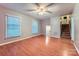 Open living room featuring wood floors, two windows and access to the staircase at 1506 Union New Hope Rd, Gastonia, NC 28056