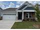 Charming single-story home with a two-car garage and well-manicured lawn at 156 Ella Claire Dr, York, SC 29745