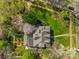 Aerial view of a home surrounded by lush greenery, mature trees, and well-maintained landscaping at 1579 Queens W Rd, Charlotte, NC 28207