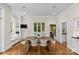 Dining area with a large window, breakfast nook, and wood floors at 1579 Queens W Rd, Charlotte, NC 28207