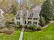 Stunning two-story home featuring a manicured lawn, dormer windows and lush landscaping creating an inviting curb appeal at 1579 Queens W Rd, Charlotte, NC 28207