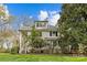 Charming two-story home with white siding, dormer windows, a welcoming front porch and lush landscaping at 1579 Queens W Rd, Charlotte, NC 28207