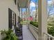 Inviting front porch featuring classic black rocking chairs, white columns and views of the manicured front yard at 1579 Queens W Rd, Charlotte, NC 28207