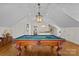 Spacious game room with a classic pool table, hardwood floors, and natural light at 1579 Queens W Rd, Charlotte, NC 28207