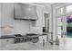 Gourmet kitchen with stainless steel range, marble counters, and subway tile backsplash at 1579 Queens W Rd, Charlotte, NC 28207