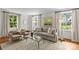 Bright living room featuring hardwood floors, neutral decor and an abundance of natural light at 1579 Queens W Rd, Charlotte, NC 28207