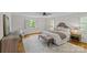 Airy primary bedroom with neutral color scheme, wood floors, and natural light from shuttered windows at 1579 Queens W Rd, Charlotte, NC 28207