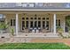 Beautiful home with a spacious patio, columns, and landscaped yard, perfect for relaxation and entertaining at 1579 Queens W Rd, Charlotte, NC 28207