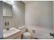 Neutral toned bathroom with a built in sink and wallpaper at 1658 Buckingham Ave, Gastonia, NC 28054