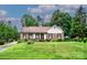 Charming single story brick home with a well-manicured lawn and mature trees at 1658 Buckingham Ave, Gastonia, NC 28054